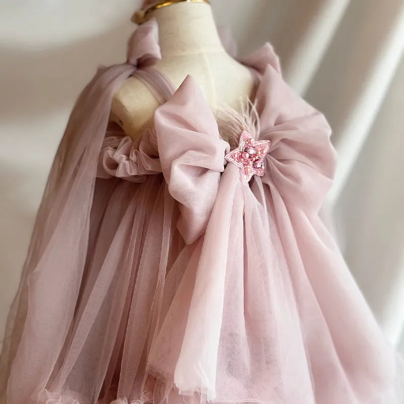 Pink children's spaghetti-strap princess dress with flower print and bow detail, cotton lining, available in 100cm to 140cm height sizes