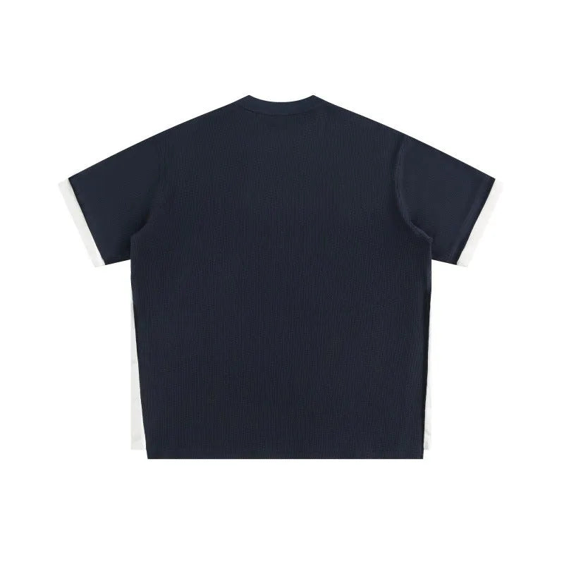 Retro alphabet embroidered loose fit short-sleeved waffle t-shirt on a hanger.