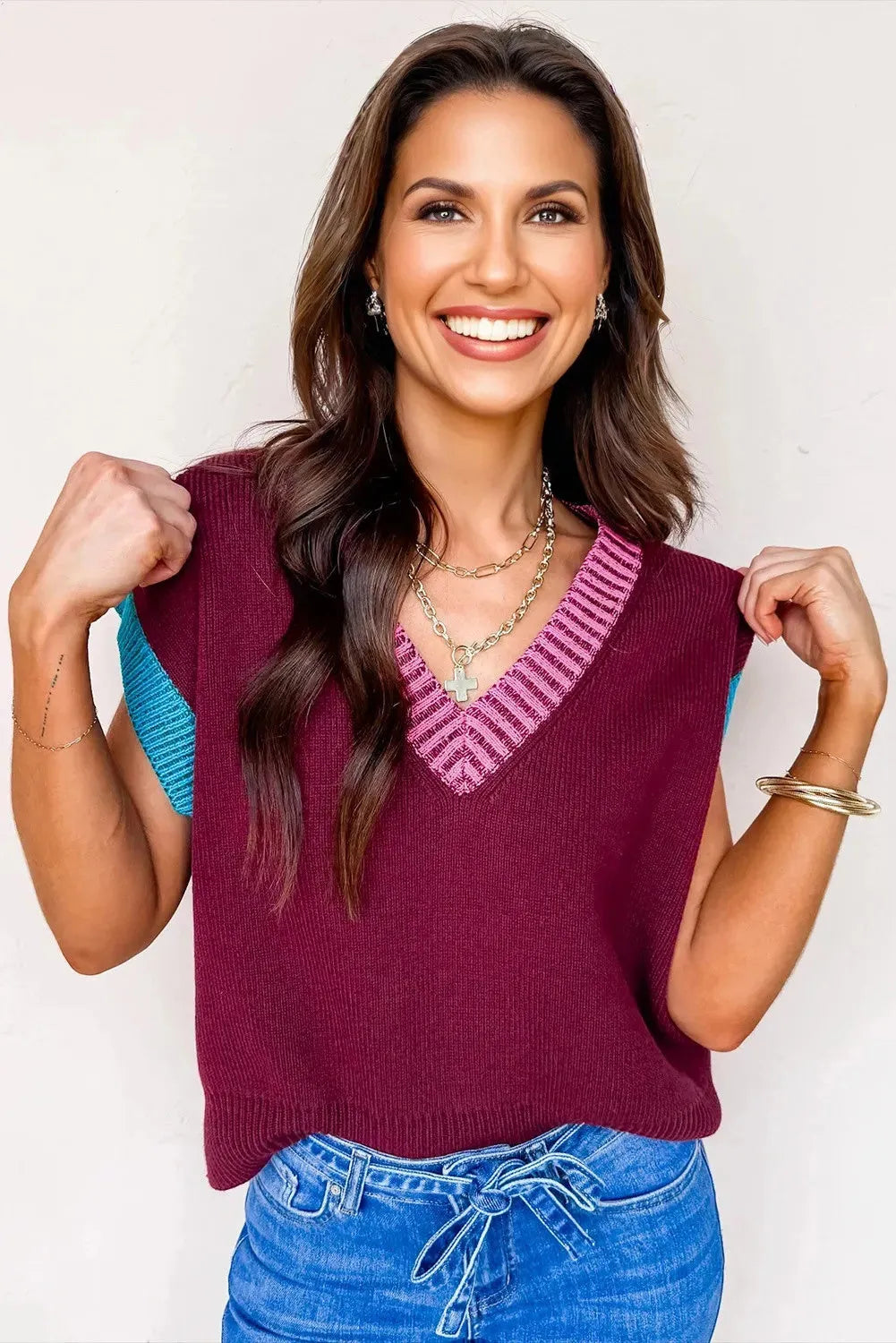 Burgundy loose-fitting V-neck sweater with short cuffed sleeves and contrast trim detail