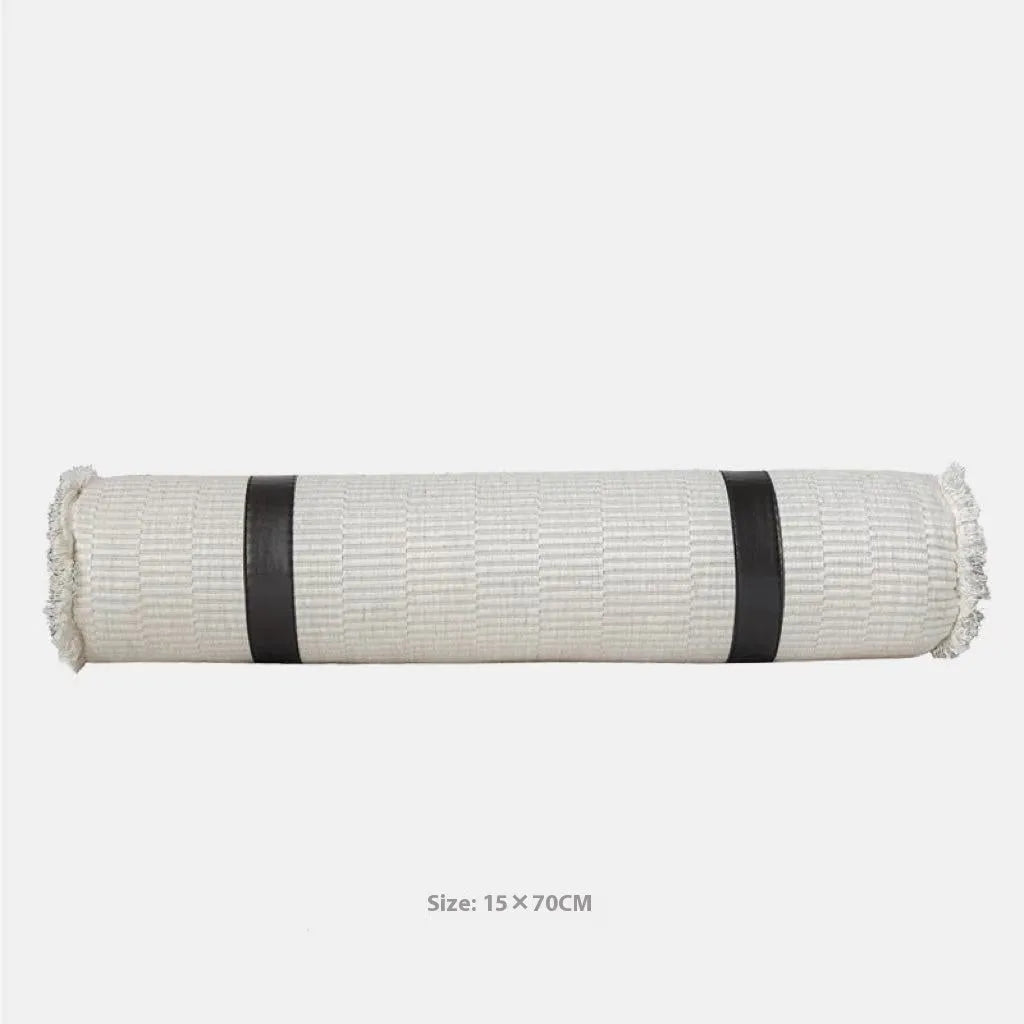 Grey and white plaid bed runner blanket set with a pillowcase and round leather pillow on a double bed.