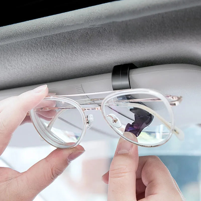 Black plastic car sunshade clip holder for glasses frames and cards measuring 6.5 by 2.3 centimetres