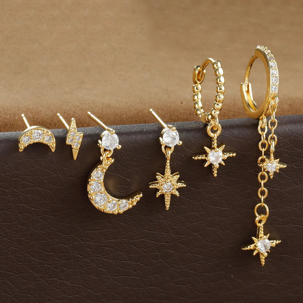 Six gold-coloured chain tassel earrings with zircon stones arranged together