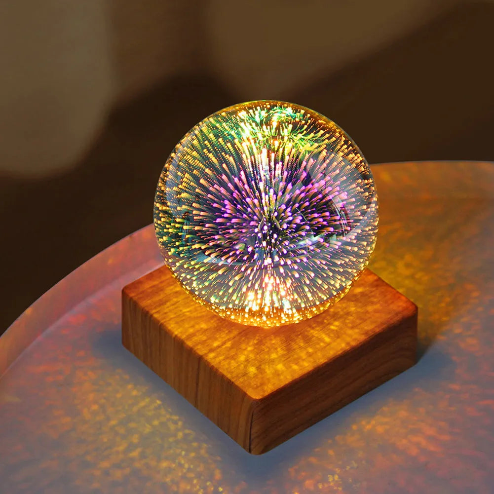 USB plug-in crystal ball night light displaying colourful firework pattern on a dark surface.