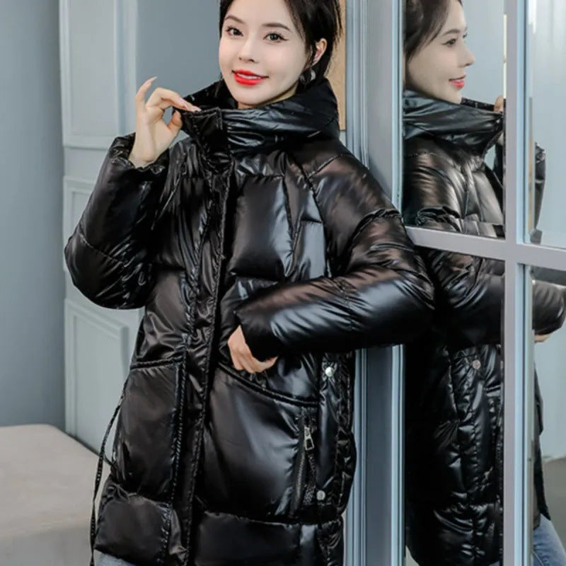 A woman wearing a loose-fit forest green hooded winter jacket, showcasing its relaxed silhouette and long sleeves.