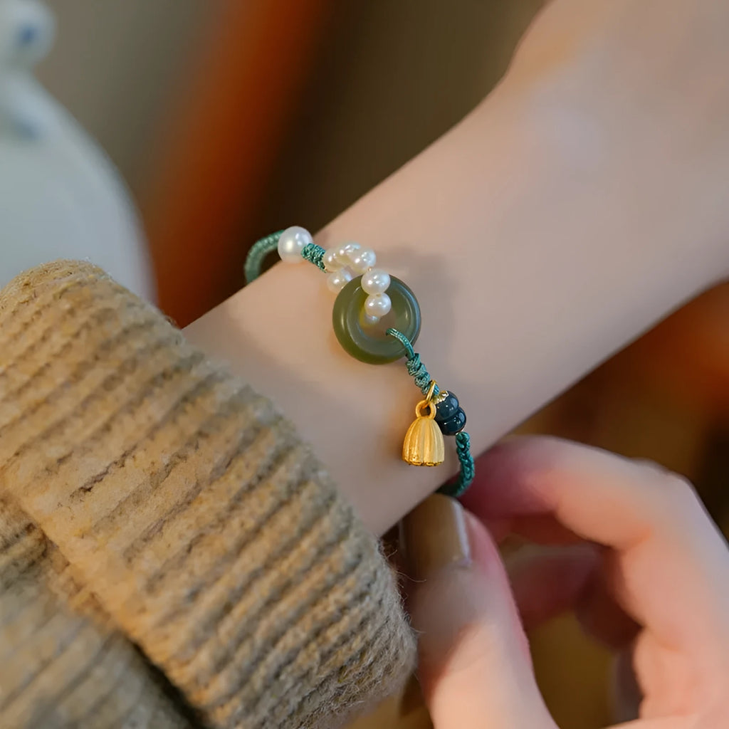 Hand-woven DIY watch band with flexible wire and a round pearl peace buckle closure.