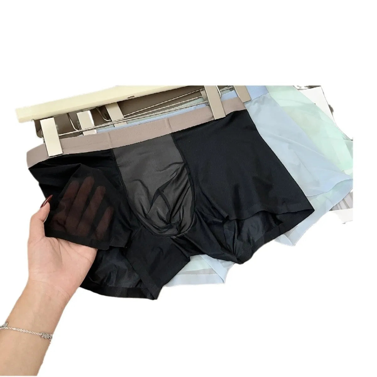 Ultra-thin ice silk men's boxer shorts with a seamless design and honeycomb crotch panel in a dark grey colour.