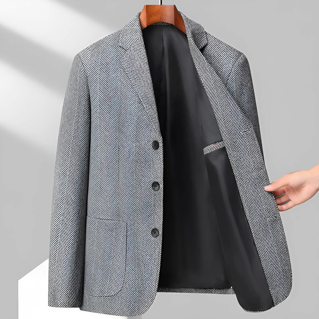A man wearing a simple, loose-fit solid-colour woolen coat suitable for spring or autumn.