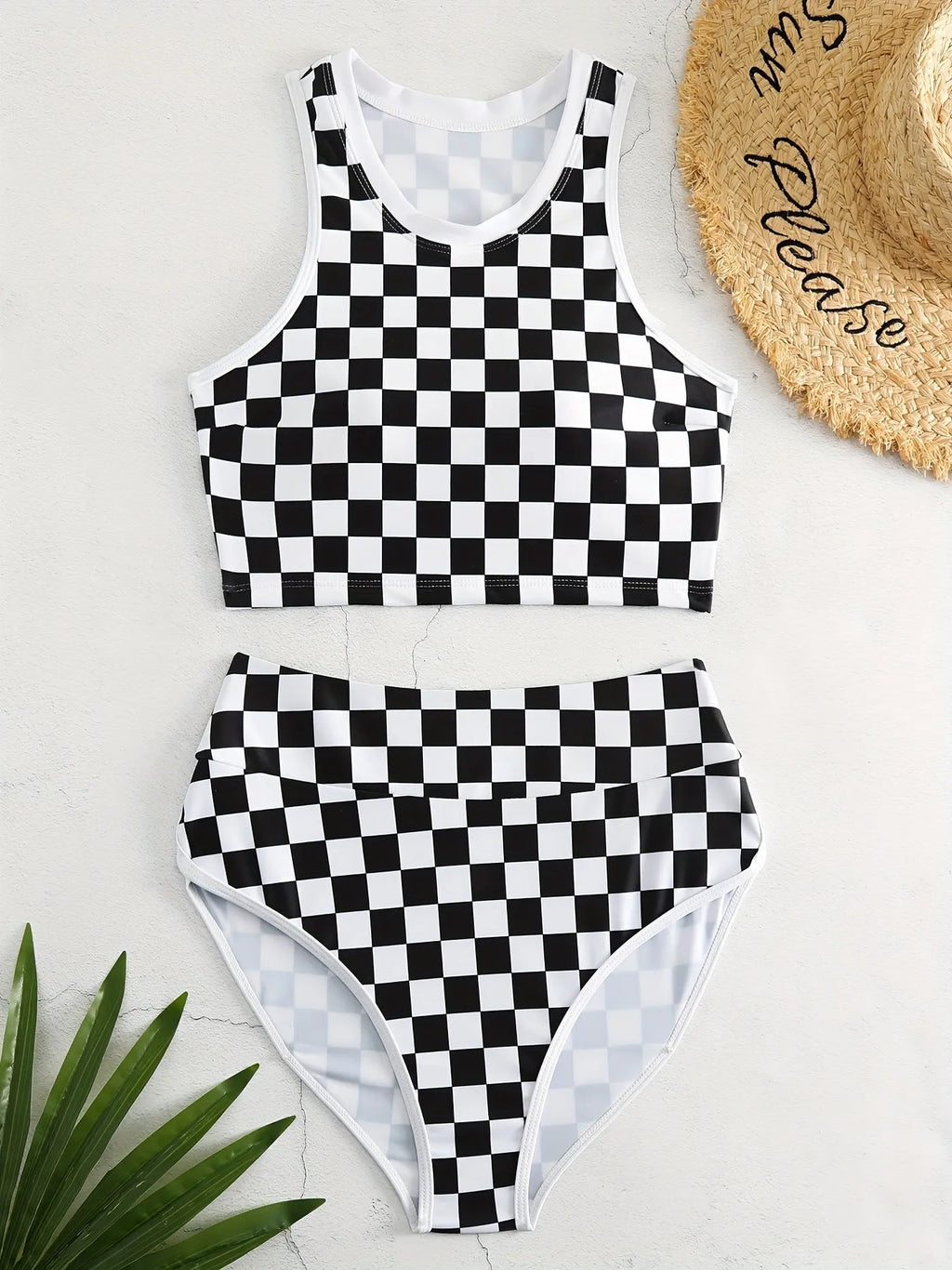 Women's black and white checkerboard racing one-piece swimsuit with backless design and suspender straps
