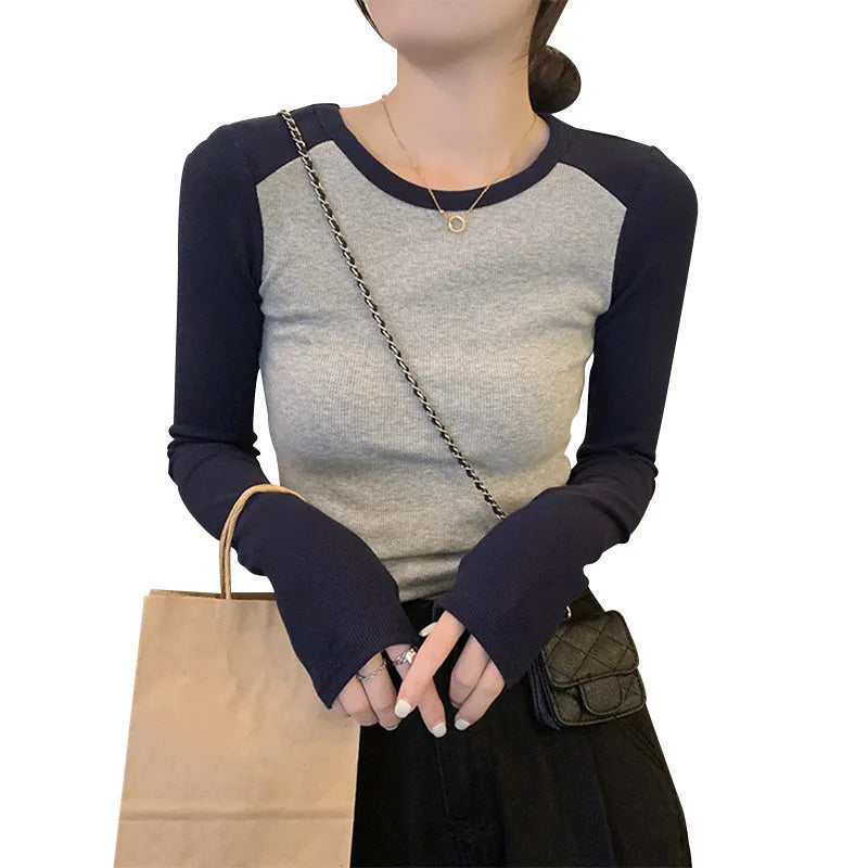 Dark blue oversized ladies top with long princess sleeves and a short hem.