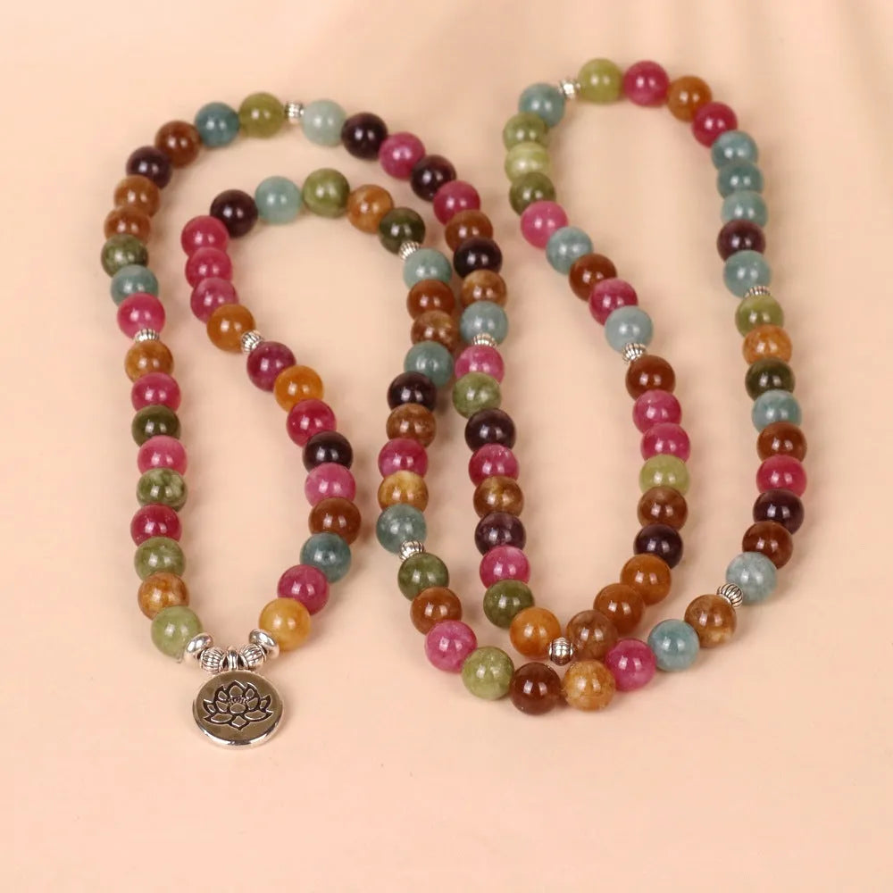 Multi-layer bracelet with 108 dark green tourmaline beads on a silver-toned alloy chain in a lotus design.