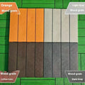 Plastic interlocking floor tiles in wood grain pattern, showing brown and grey colour options.
