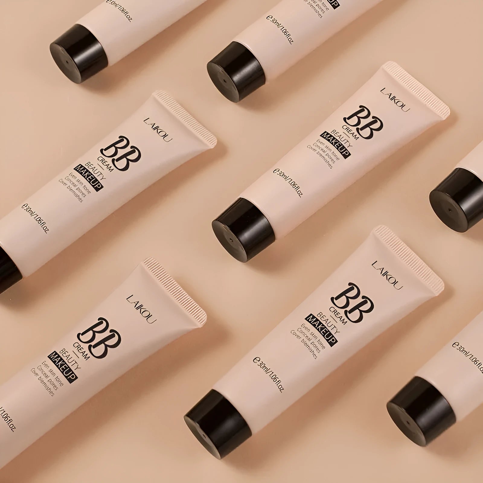 30ml tube of BB cream shown alongside swatches of its nine shades from light ivory to dark brown.