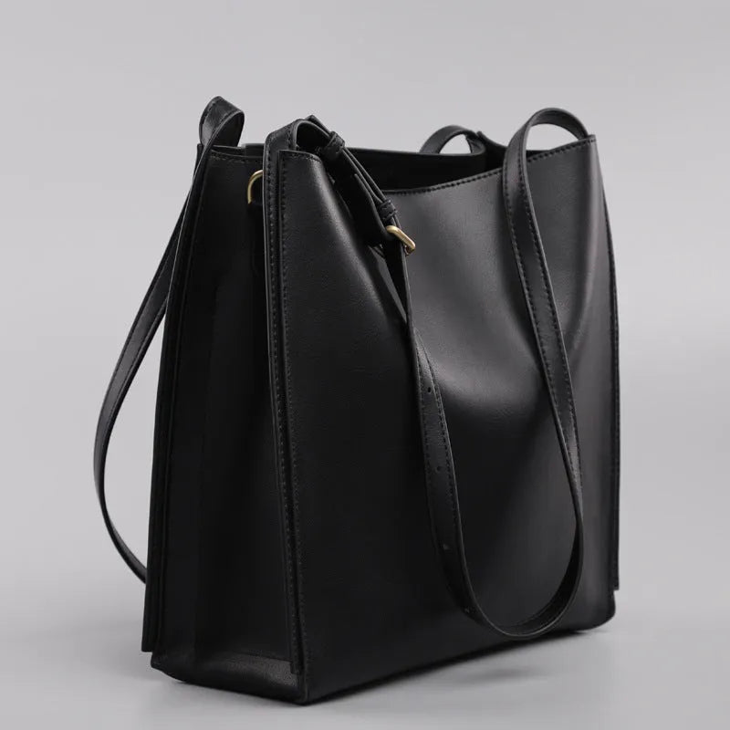 Brown genuine leather retro-style women's commuter bag with dual shoulder straps and external slit pocket.