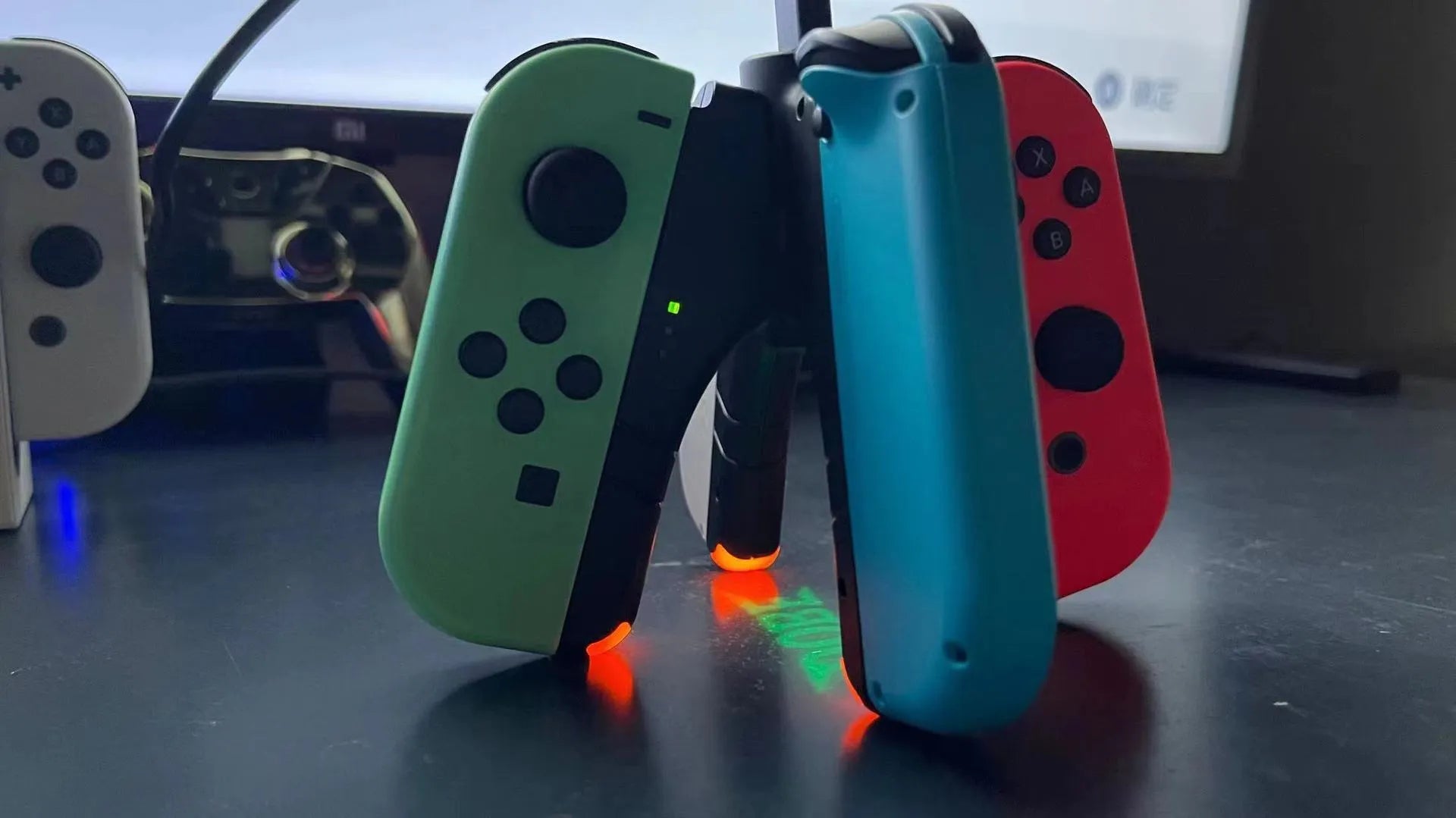 Black four-in-one charger holder for Switch, attached to handle ends with Type-C interface.