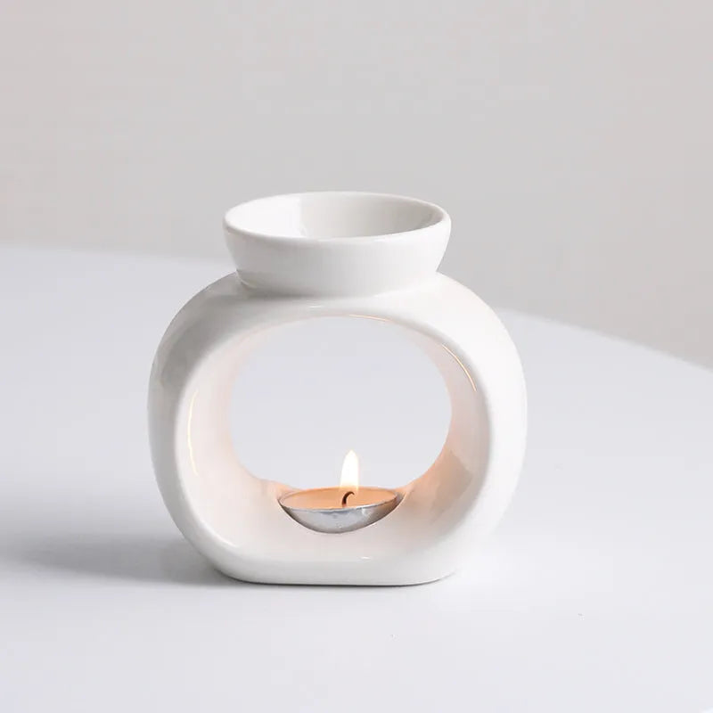 White Nordic style ceramic aromatherapy stove ornament on a wooden surface.