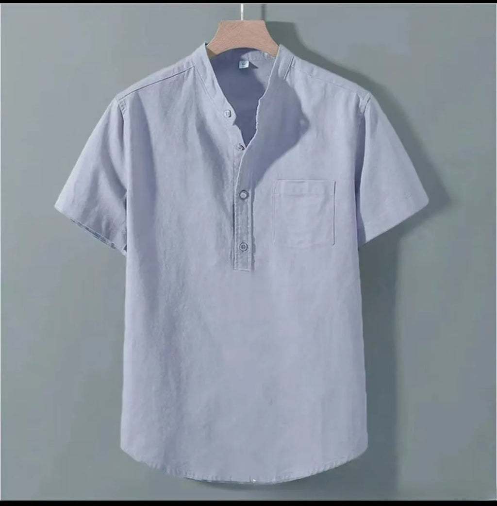 Man wearing a beige loose-fit slub linen casual shirt with a stand collar and short sleeves.