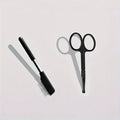 Black pet grooming brush with soft silicone bristles and comb attachment for dogs and cats