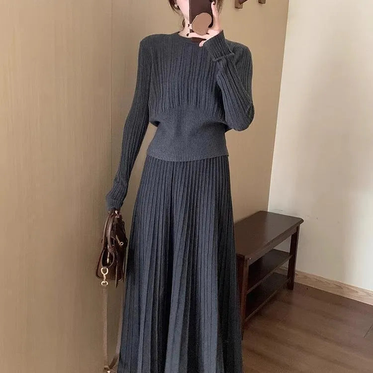 Dark grey knitted sweater and skirt set with a raised 3D pattern, shown as a complete artistic retro outfit.