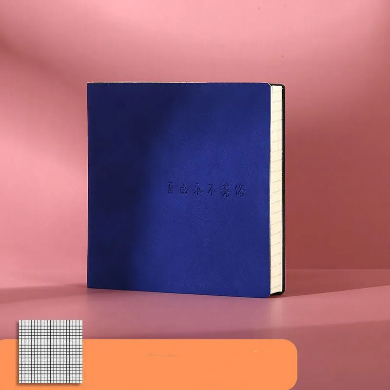 Square faux leather notebook open on a table, showing Daolin paper and French fold binding.