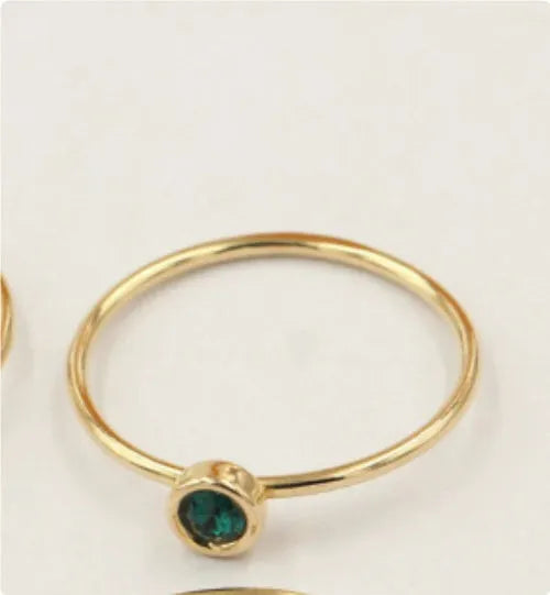 Women's copper knuckle ring with 14K gilding and zircon stones in green, blue, dark red, or white.