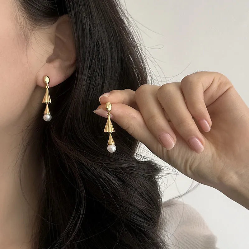 Gold geometric fringe ear clip earrings with long wind chime mosquito coil plate design on copper base