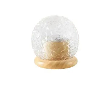 Projector night lamp with water ripple effect and remote control on a bedside table