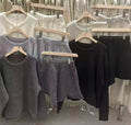 Women's loose-fitting grey acrylic knitted long sleeve sweater and wide leg shorts two-piece set.