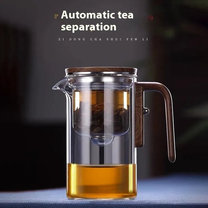 Glass teapot with wooden handle showing magnetic separation inner container and drip-free spout.
