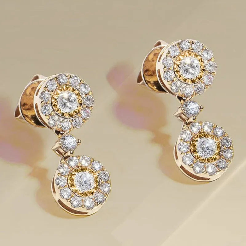 Women's gold copper round zircon stud earrings on a light background