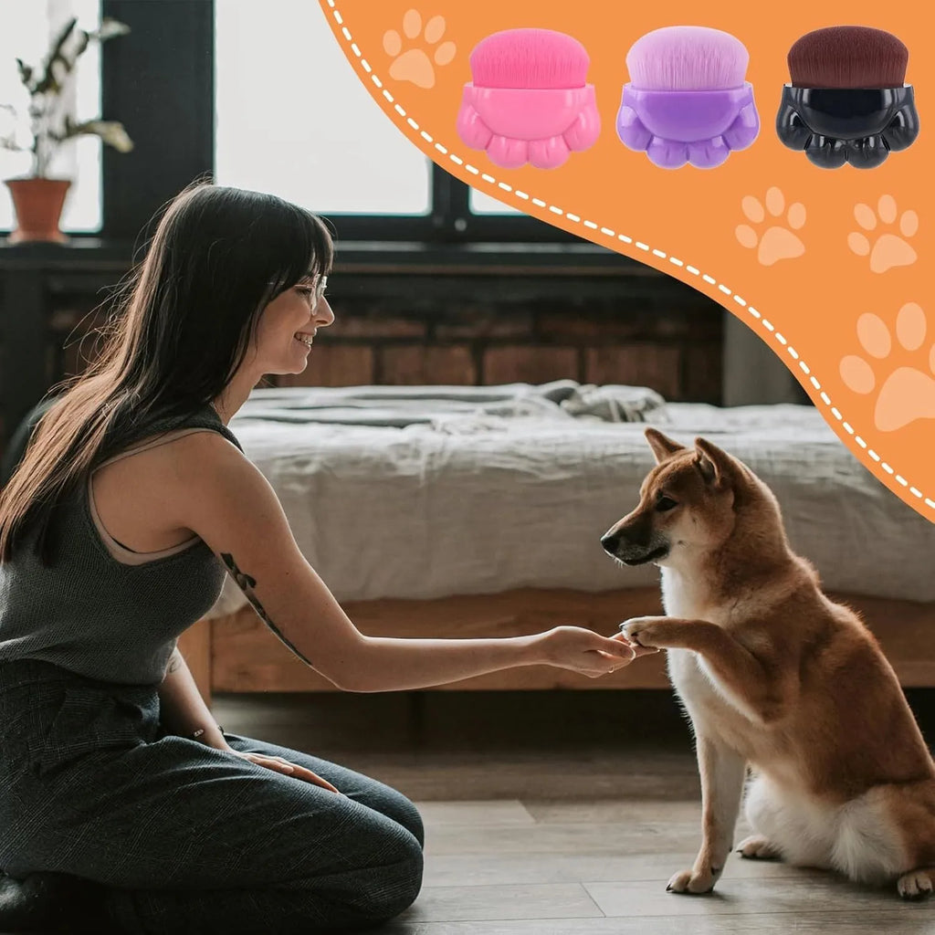 Three paw-shaped pet balm brushes with soft fibre heads in plastic storage boxes
