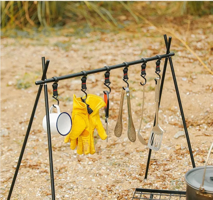 Aluminium alloy portable folding clothes drying rack with triangular frame and top tray, set up outdoors.
