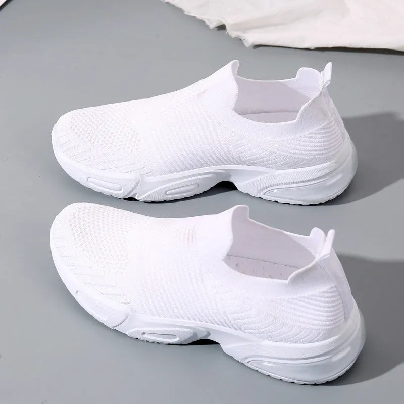 A pair of low-top slip-on sock shoes in a choice of colours, showing the mesh lining and lightweight PVC sole.