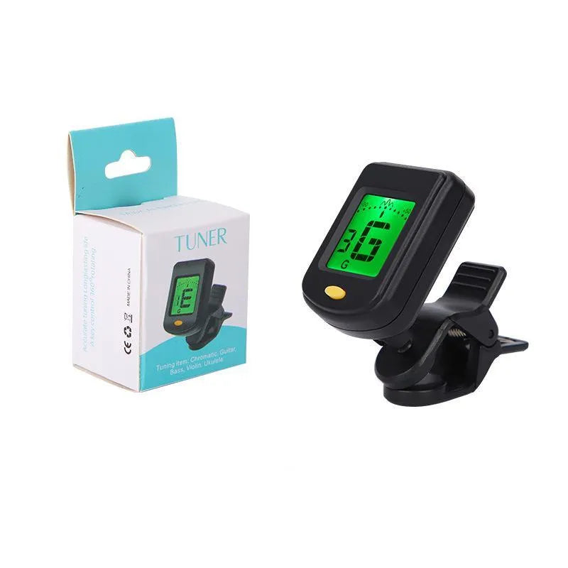 Automatic clip-on multi-function guitar tuner with LCD display attached to an acoustic guitar headstock