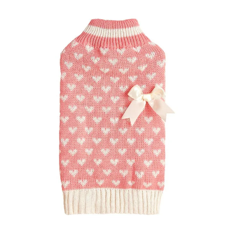 Dog wearing acrylic sweater with embroidered bow and heart patterns