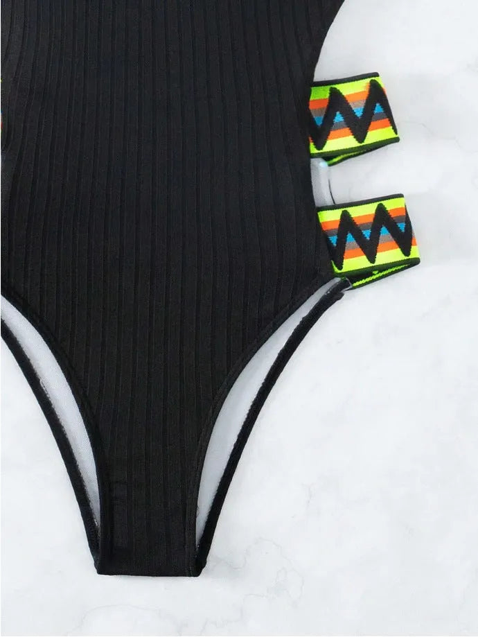 Black solid colour one-piece bikini swimsuit for women laid flat, showing front design