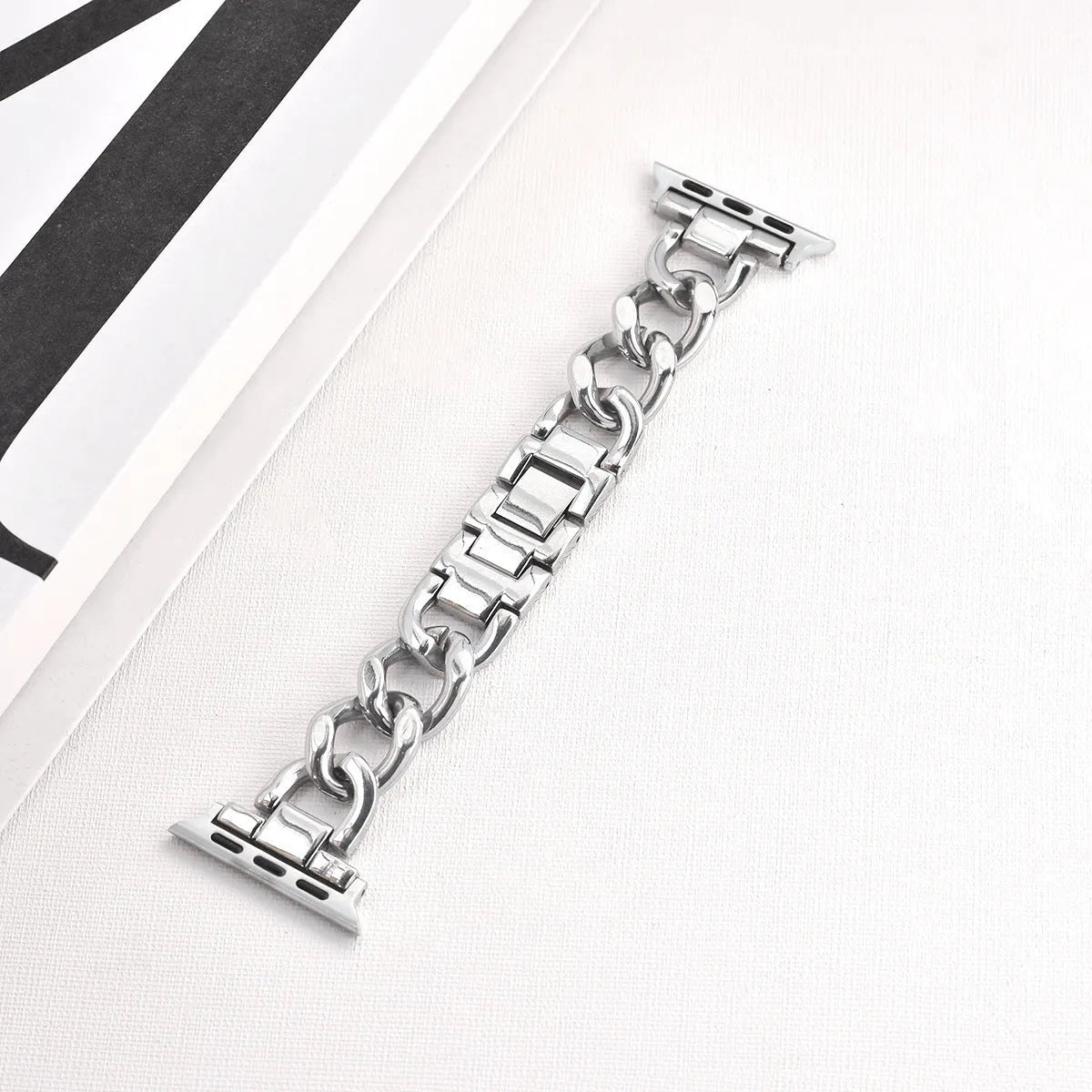 Metal denim chain Apple Watch strap in silver, black, gold, rose gold, and Starlight colours showing textured design