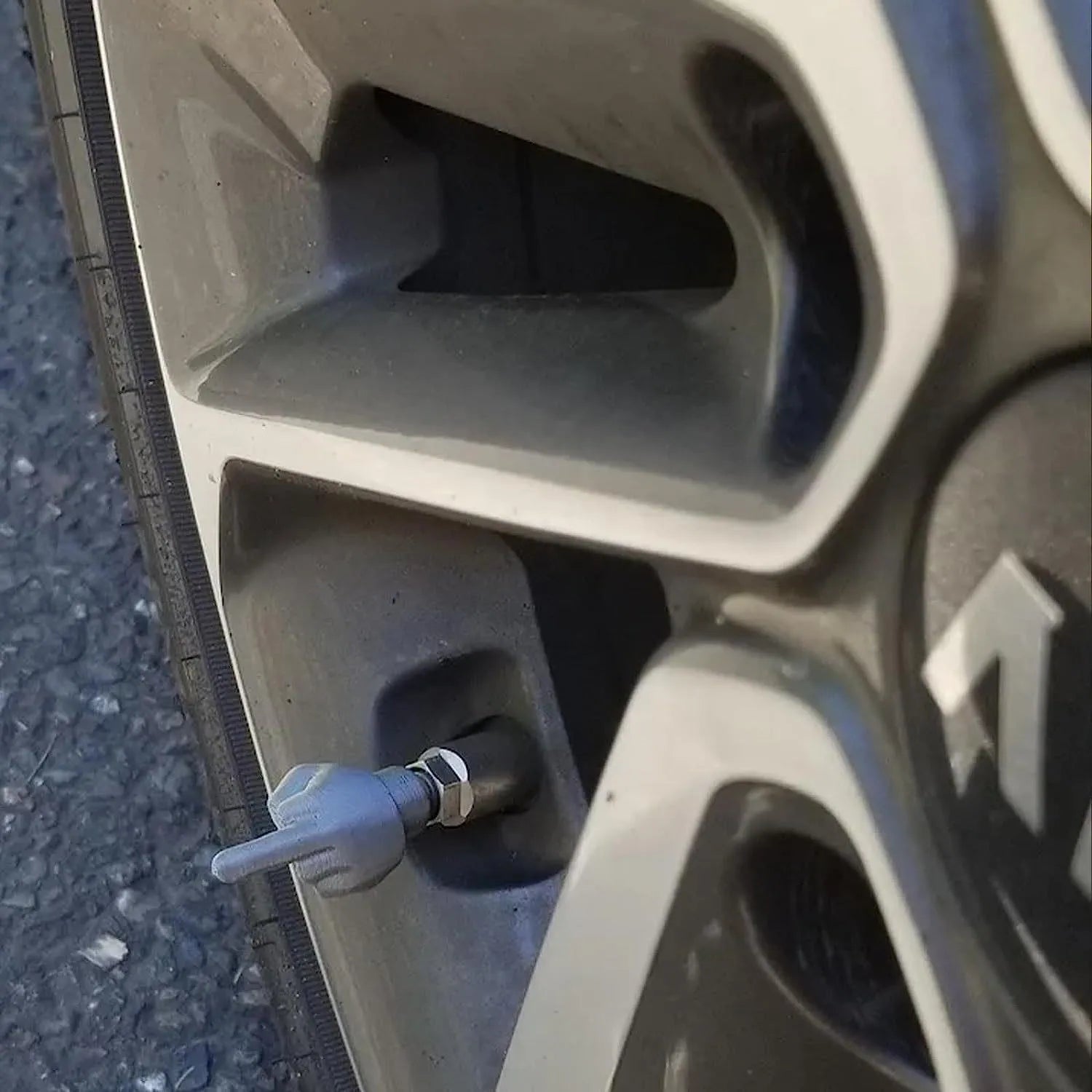 Four latex tyre valve caps shown in black and skin colours for car and motorcycle dust protection