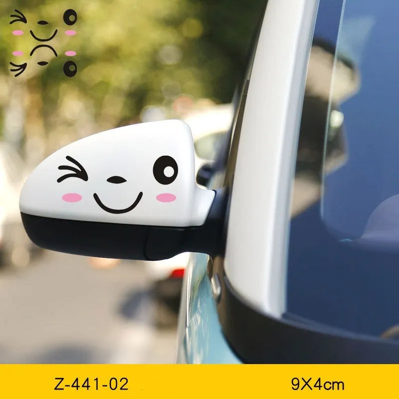 Pair of reflective cartoon eye car stickers on a vehicle rearview mirror and door panel.