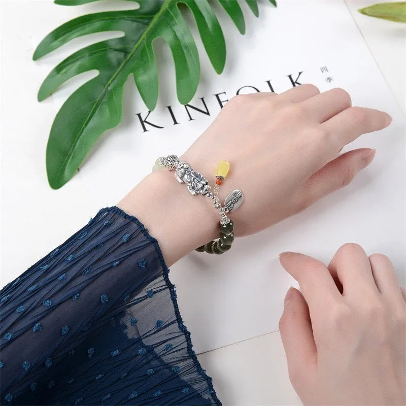 Retro women's silver coin bracelet with a natural Hetian jade stone.
