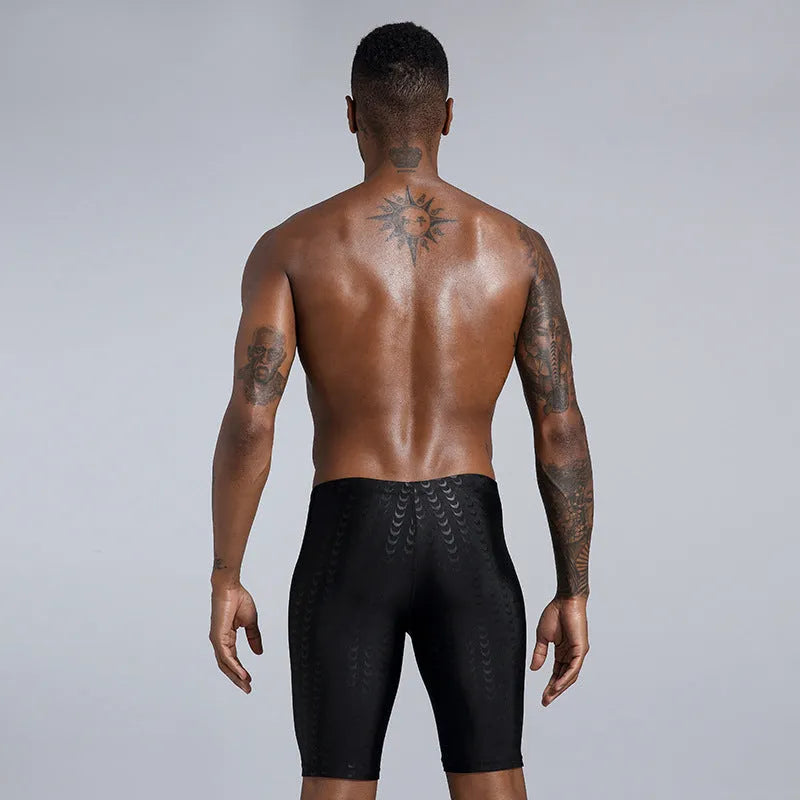 Men's solid colour polyester swimming trunks shown in boxers and cropped pants styles.