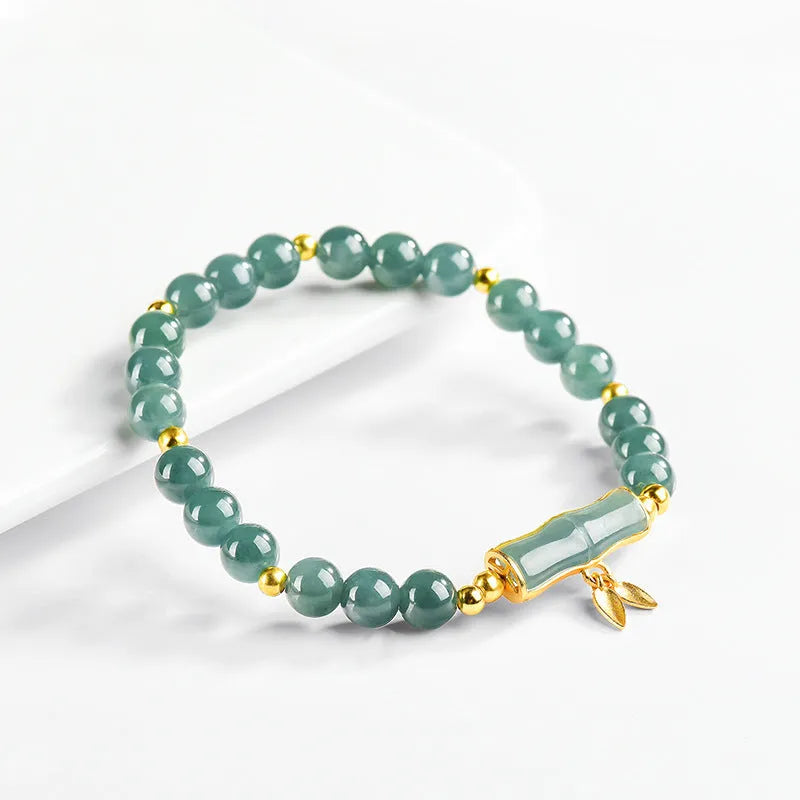 Women's silver bracelet with natural jade and blue beads in a simple high-rise design.
