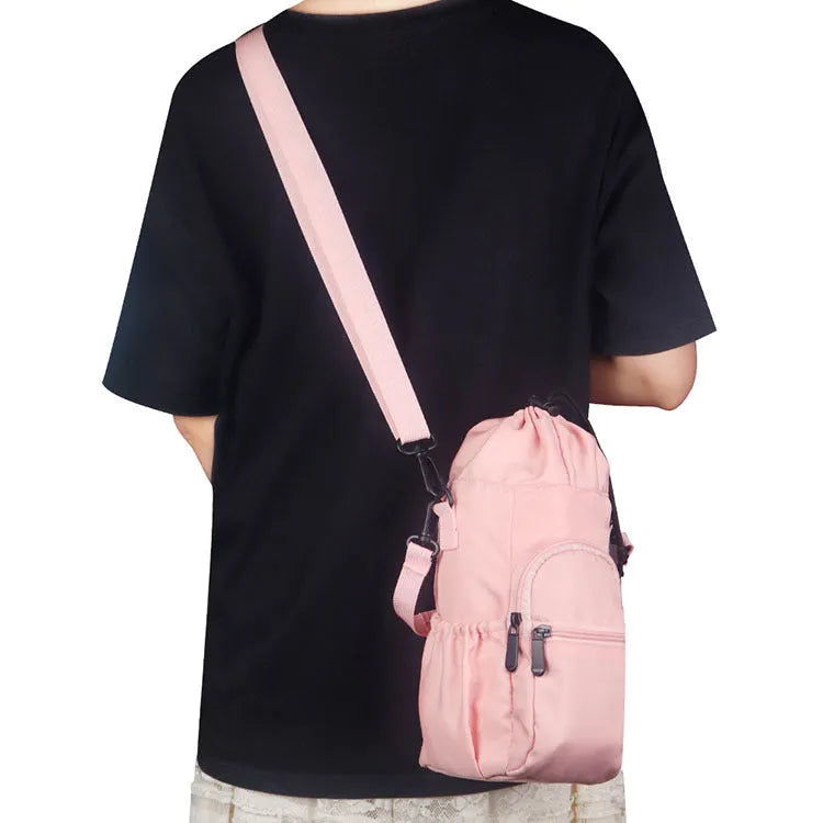 Cloth crossbody water bottle pouch in black, adjustable strap for hands-free carrying.