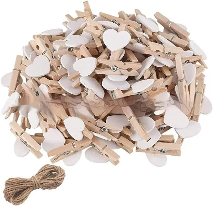 Set of five handmade wooden heart-shaped decorative clips in assorted colours.