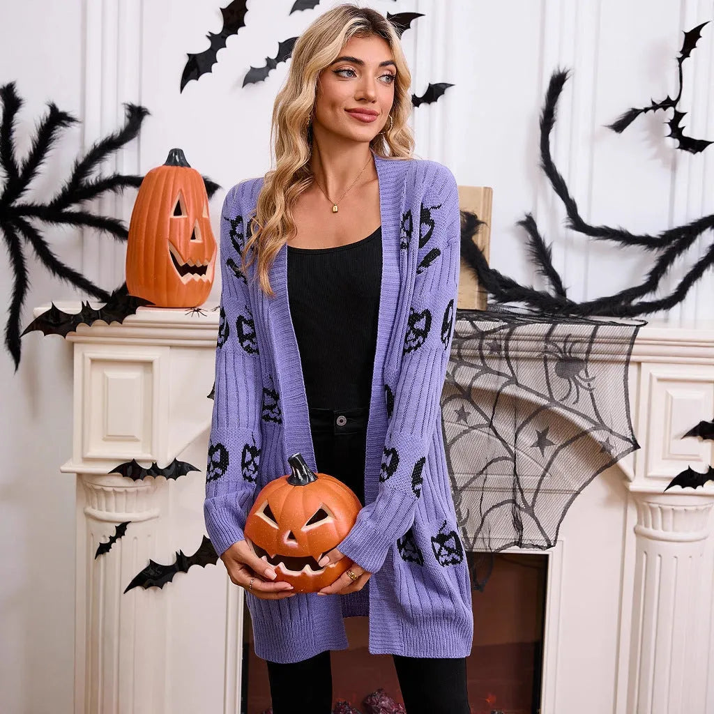 Women's black cardigan with orange knitted pumpkin head jacquard pattern.