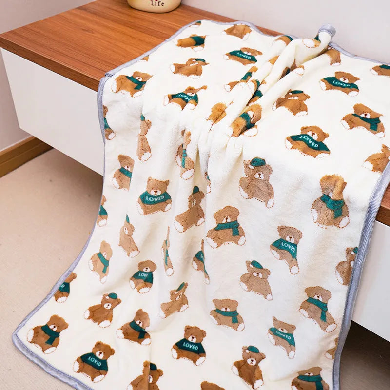 Soft warm pet blanket in pink for dogs and cats, size M, on a pet bed