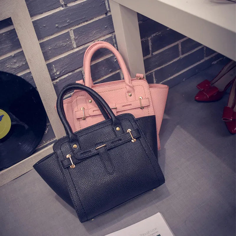 Women's PU messenger bag in black with zipper pocket and shoulder strap, top view with mini iPad inside.