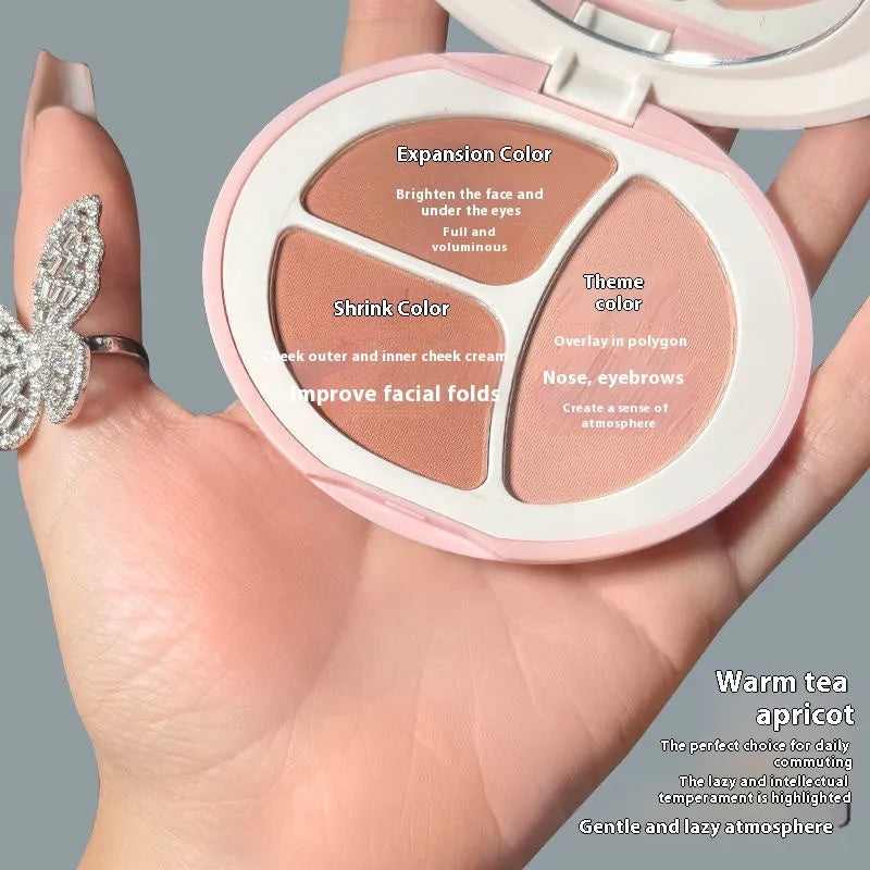 Tricolor blush palette showing three matte shades: peach, apricot, and mauve-pink