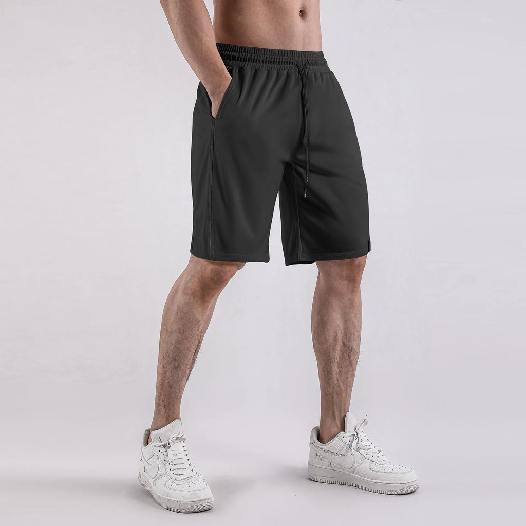 Man wearing black quick-dry mesh capri shorts with a loose, casual fit.
