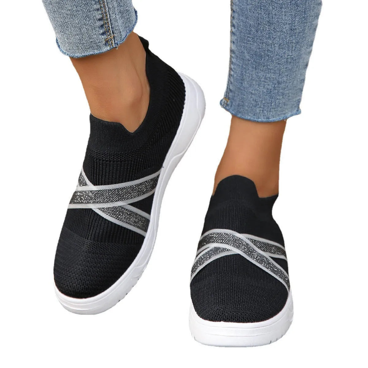 Black women's low-top flyknit mesh flat shoes with round toe and tassel detail on a rubber sole.