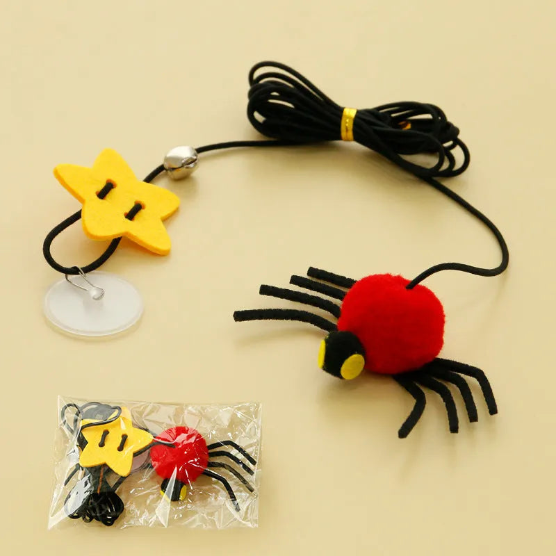 Red and yellow hanging cat toy with elastic rope, feather ball, bell and spider attachment for door mounting